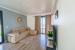 a living room with a couch and a table at Eva's house in São Vicente