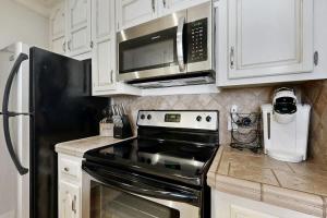 a kitchen with a black stove and a microwave at Polk 401 in Nashville +7 photos