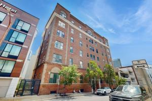 a tall brick building with a car parked in front of it at Polk 401 in Nashville