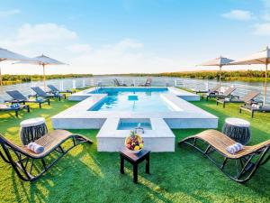 a pool on a cruise ship with chairs and a table at Mövenpick MS Sunray in Luxor