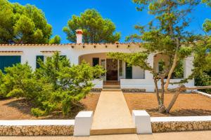 a white house with trees in front of it at Villa Trepuco Dos in Punta Prima
