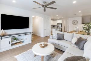 a living room with a couch and a flat screen tv at Heated Pool & Pickleball - Spacious & Immaculate Home in Washington