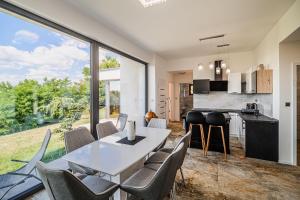 a kitchen and dining room with a table and chairs at Apartma Belvi in Brežice +13 photos