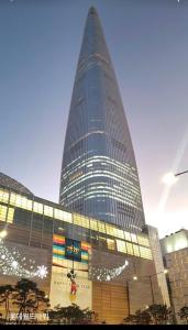 a tall building with a sign in front of it at 원하우스 in Seoul