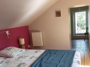 a bedroom with a bed and a window at Maison d'Hotes ZEN in La Saunière +4 photos