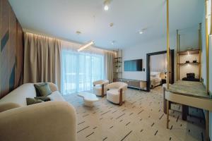 a hotel room with a living room with a mirror at Mariental Hotel & SPA in Szklarska Poręba