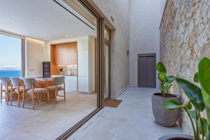 a kitchen and dining room with a table and chairs at Deciel Cave Villa in Áyios Pétros +22 photos