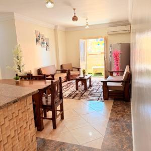 a living room with couches and a table and chairs at Halla season matrouh in Marsa Matruh
