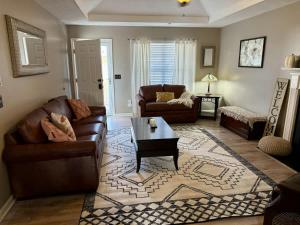 a living room with a couch and a coffee table at Mount Juliet Charmer in Hunters Store