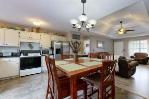 a kitchen and dining room with a table and chairs at Mount Juliet Charmer in Hunters Store