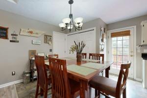 a dining room with a wooden table and chairs at Mount Juliet Charmer in Hunters Store