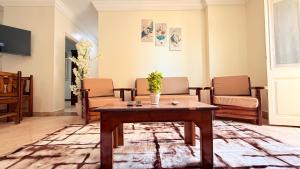 a living room with a table and chairs at Halla season matrouh in Marsa Matruh