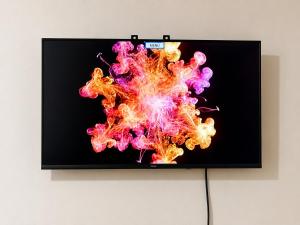 a television screen with colorful smoke on it at EL Viajero ll in Estelí