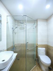 a bathroom with a shower and a toilet and a sink at Khách sạn Phúc Thành in Hanoi