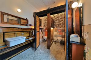 a bathroom with a sink and a toilet at Tiny Boat Berta in Ottenbüttel +12 photos