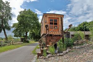a small wooden house on the side of a road at Tiny Boat Berta in Ottenbüttel