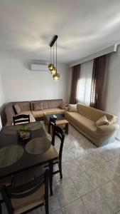 a living room with a couch and a table at The Fernvills in Nea Kallikrateia