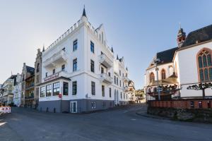 a white building on the side of a street at Karmeliterhof Studios & Suites in Boppard