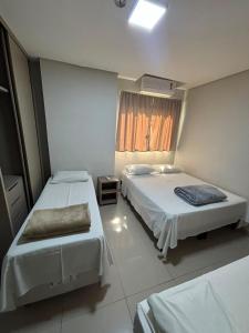 a hotel room with two beds and a window at Hotel Accordes in Campo Grande +38 photos