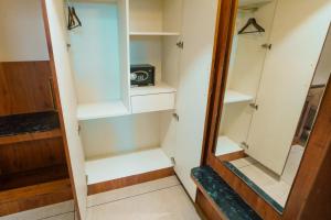 a walk in closet with a mirror at Sri Vishnu Grand in Vellore +15 photos