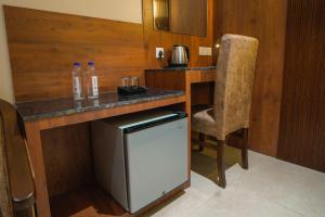 a small kitchen with a counter and a chair at Sri Vishnu Grand in Vellore