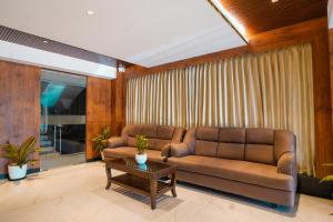 a living room with a couch and a table at Sri Vishnu Grand in Vellore