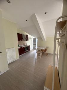 an empty room with a table and a kitchen at La Concordia Serravalle Outlet in Serravalle Scrivia