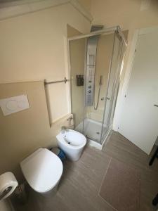 a bathroom with a toilet sink and a shower at La Concordia Serravalle Outlet in Serravalle Scrivia +5 photos