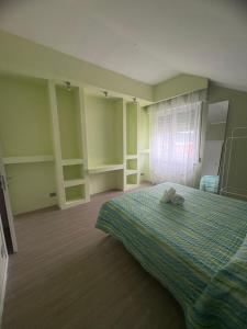 a bedroom with a bed with a towel on it at La Concordia Serravalle Outlet in Serravalle Scrivia