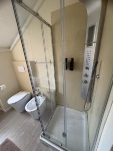 a bathroom with a shower and a toilet at La Concordia Serravalle Outlet in Serravalle Scrivia