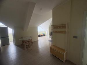 a living room with a table and a refrigerator at La Concordia Serravalle Outlet in Serravalle Scrivia