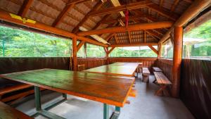 a dining room in a cabin with tables and benches at Chata Motocentrum in Snina