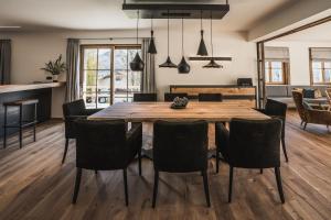 a dining room with a wooden table and chairs at Chalet am Wetterkreuz in Reit im Winkl +72 photos