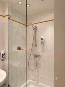 a bathroom with a shower with a glass door at Hotel Prinz Eugen Vienna in Vienna +52 photos