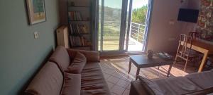 a living room with a couch and a table at Mesakti in Armenistis