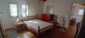 a bedroom with a bed and a red dresser in it at Mesakti in Armenistis