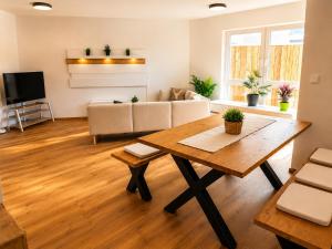a living room with a table and a couch at Schongau Suites Premium Apartments XL in Schongau