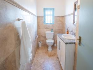 a bathroom with a toilet and a sink at Rose Pearl in Paternoster