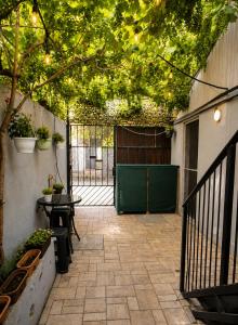 a patio with a fence and a gate with lights at Magic Box in Constanţa