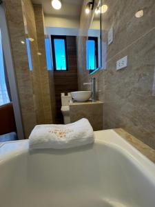 a bathroom with a bath tub and a sink at Hotel San Miguel Cusco in Cusco