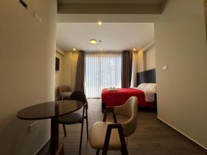 a hotel room with a bed and a table and chairs at Hotel San Miguel Cusco in Cusco