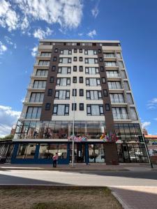 a tall building with a person standing in front of it at Hotel San Miguel Cusco in Cusco