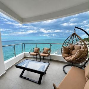 a living room with a hammock and a view of the ocean at Escape Reef in Watamu