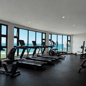 a gym with a row of treadmills and machines at Escape Reef in Watamu