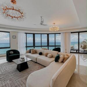 a large living room with a large couch and chairs at Escape Reef in Watamu +4 photos
