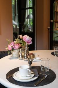 a table with a plate and a cup and aucer at B&B 't Wit Huys Brugge in Bruges