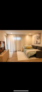 a bedroom with a bed and a television in it at Modern private apartment - Warm atmosphere in Repentigny