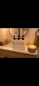 a candle is sitting on a counter in a bathroom at Modern private apartment - Warm atmosphere in Repentigny
