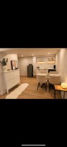 a living room with two chairs and a table at Modern private apartment - Warm atmosphere in Repentigny