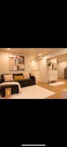 a living room with a couch and a table at Modern private apartment - Warm atmosphere in Repentigny +4 photos